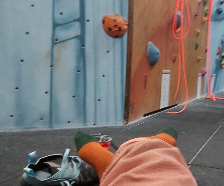Looking at climbing wall with curiosity